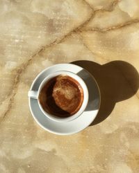 Directly above shot of cappuccino served on table