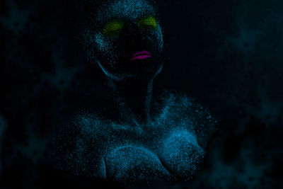 Woman with eyes closed in neon make-up