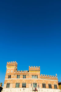 Low angle view of historical building against blue sky