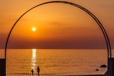 Scenic view of sea against orange sky