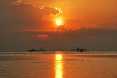 Scenic view of sea against orange sky