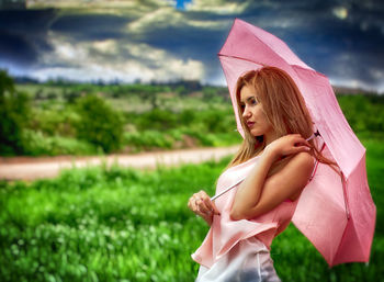 Girl holding flower in park