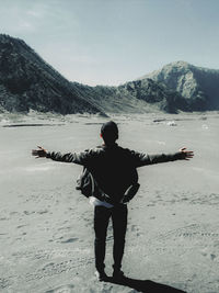 Rear view of man standing on mountain