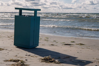 Lifeguard hut on beach against sky