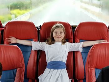 Portrait of a smiling girl sitting in car