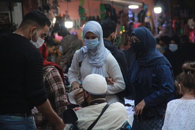 People on street in city at night