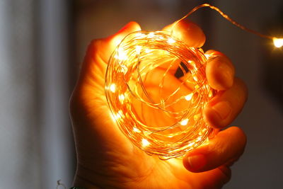 Close-up of hand holding illuminated light