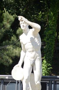 Low angle view of statue against trees