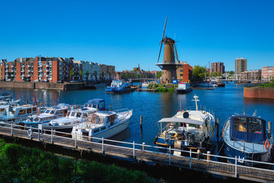 View of the harbour of delfshaven and the old grain mill de destilleerketel. rotterdam, netherlands