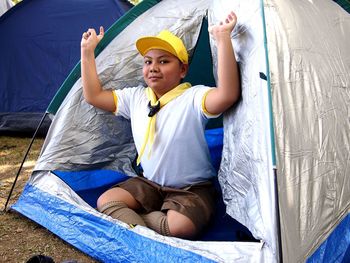 Portrait of boy sitting in tent