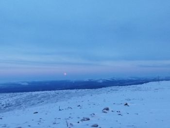 Scenic view of snow covered mountains against sky