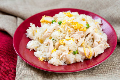 Close-up of fried rice in plate on tablecloth