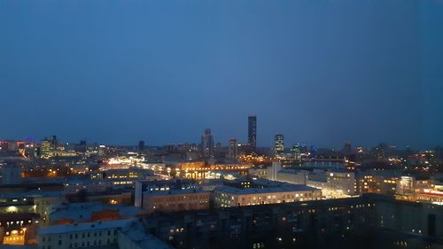 High angle view of illuminated buildings against sky at night