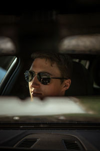 Portrait of young man in car