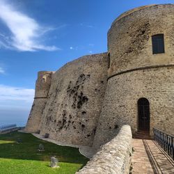 Low angle view of historical building against blue sky