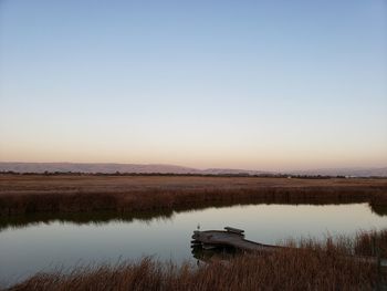 Scenic view of lake against sky during sunset