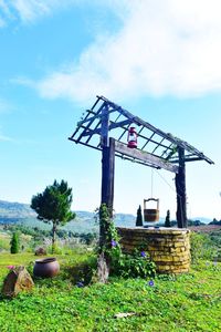 Traditional windmill on field against sky