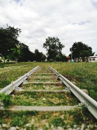 Surface level of railroad track against sky