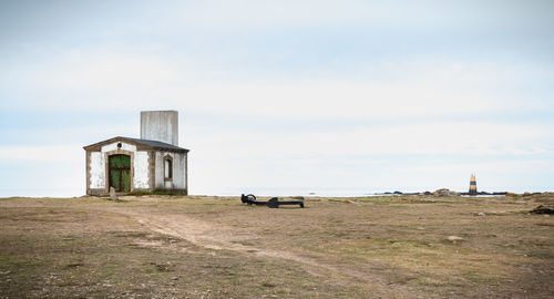 Old building on field against sky