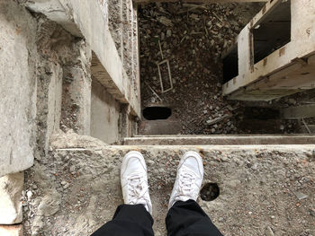 Low section of man standing in abandoned building