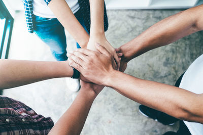 Low section of people holding hands