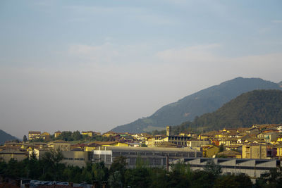 Town by mountains against sky