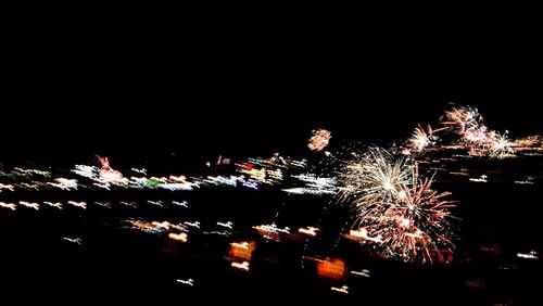 Low angle view of firework display against sky at night