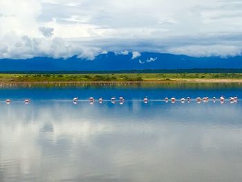 Scenic view of lake against cloudy sky