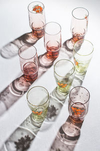 High angle of glasses with back light and beautiful shadows on the white background. copy space