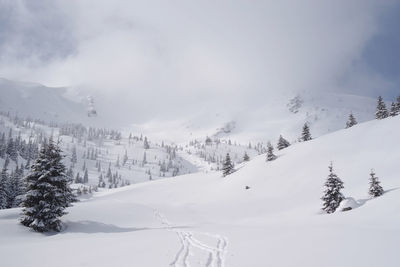 Scenic view of snow covered mountains against sky