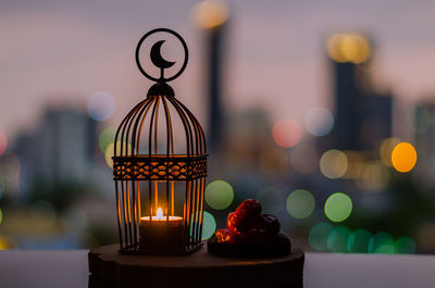 Close-up of illuminated candles on table