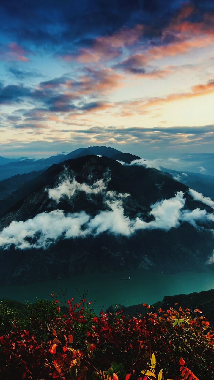 mountain, scenics, sky, beauty in nature, cloud - sky, mountain range, tranquil scene, weather, tranquility, sunset, landscape, nature, season, cloudy, dramatic sky, idyllic, winter, orange color, high angle view, snow