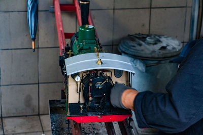 Cropped hand of mechanic working at workshop