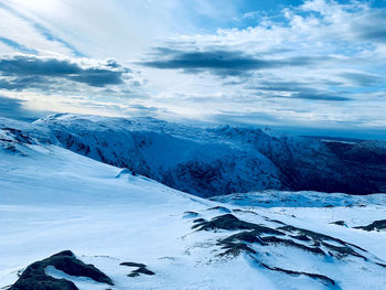 Scenic view of snow covered mountains against sky