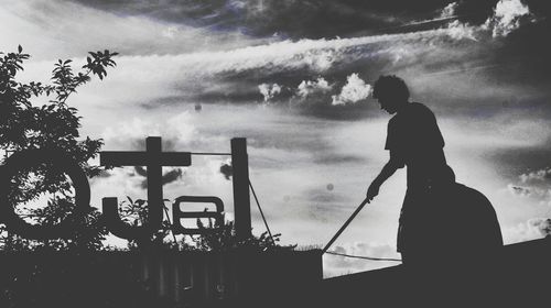 Silhouette of woman against sky