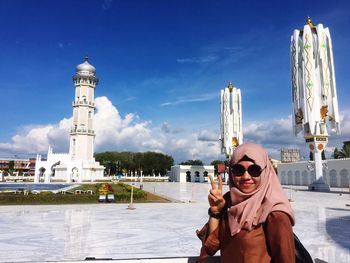 Portrait of mid adult man standing against sky