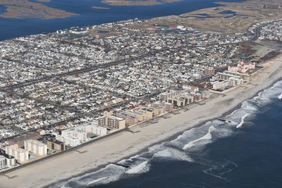 High angle view of city buildings by sea