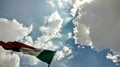Low angle view of flag against cloudy sky