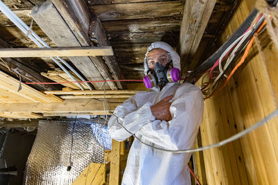Low angle view of man working on ceiling