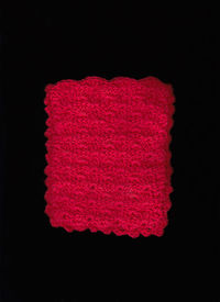 Directly above shot of pink art over black background