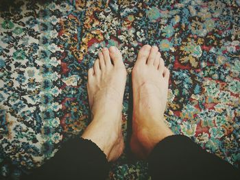 Low section of woman standing on tiled floor