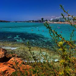 Scenic view of sea against clear blue sky