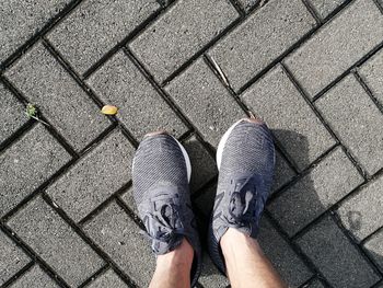 Low section of man standing on footpath