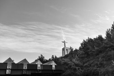 Low angle view of traditional windmill against sky