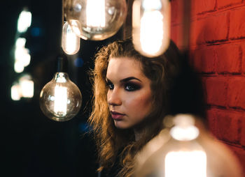 Portrait of woman with illuminated lighting equipment