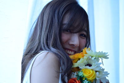 Portrait of woman holding flower bouquet