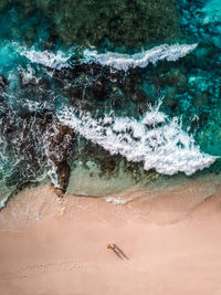 Aerial view of people at sea shore