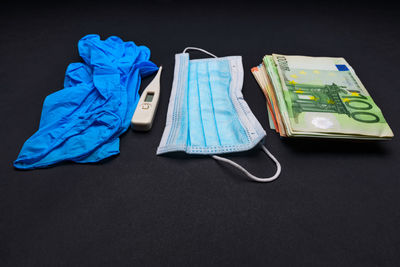 High angle view of blue paint on table against black background