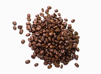 High angle view of coffee beans against white background