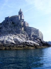 Building by sea against sky